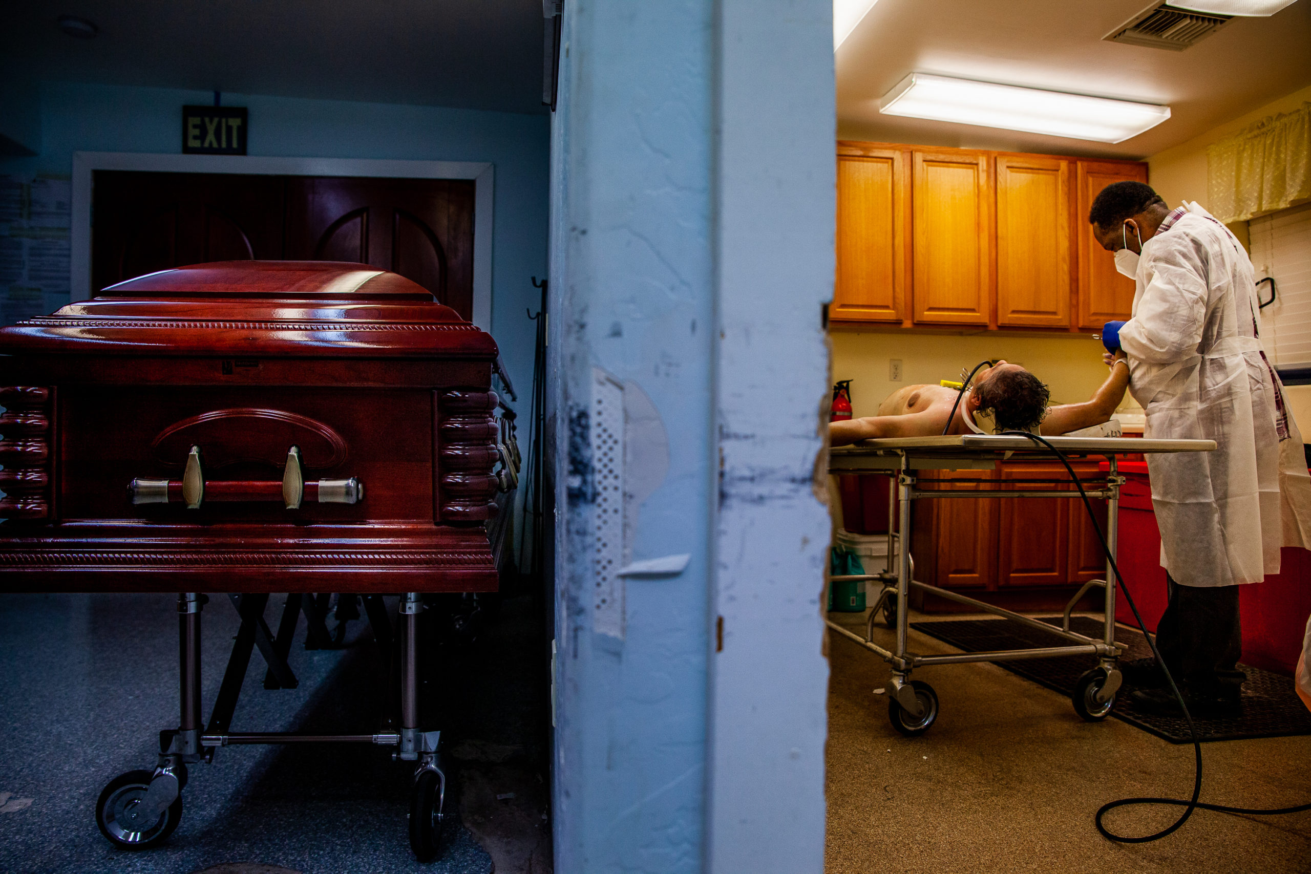Ron Thornson embalms a body at a funeral home in Mesa, Ariz., on March 18, 2021. Thornson helped relieve pressure on other funeral workers in the Phoenix area by performing embalmings at mortuaries with surging workloads. Although some funeral workers ref